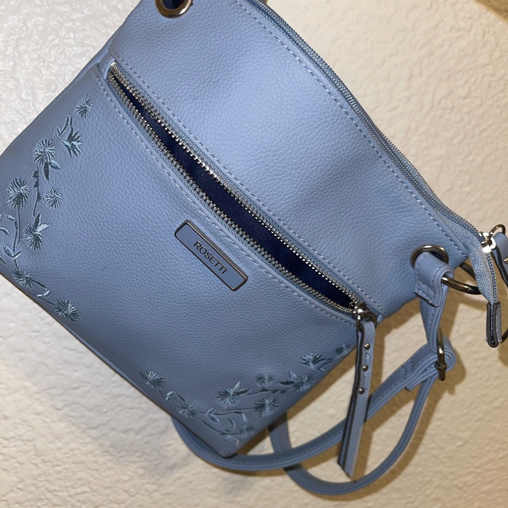 Im selling this pretty rosetti cros body is has never been worn. Nude blue color